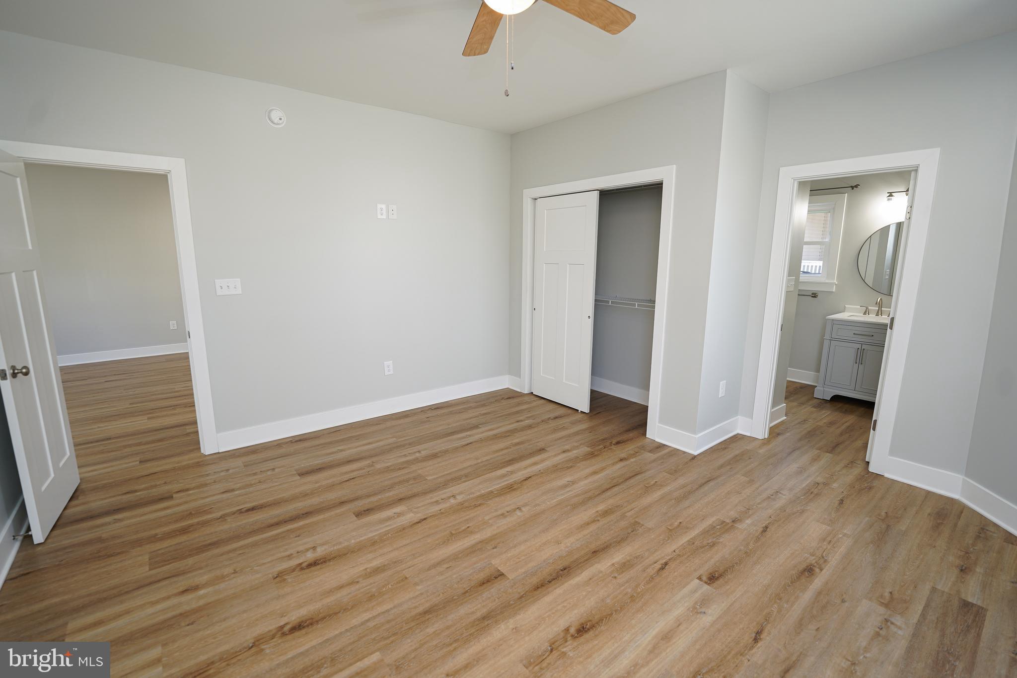 111 East Jewell Street Delmar, DE 19940 - Photo 24 of 59 an empty room with wooden floor and a ceiling fan
