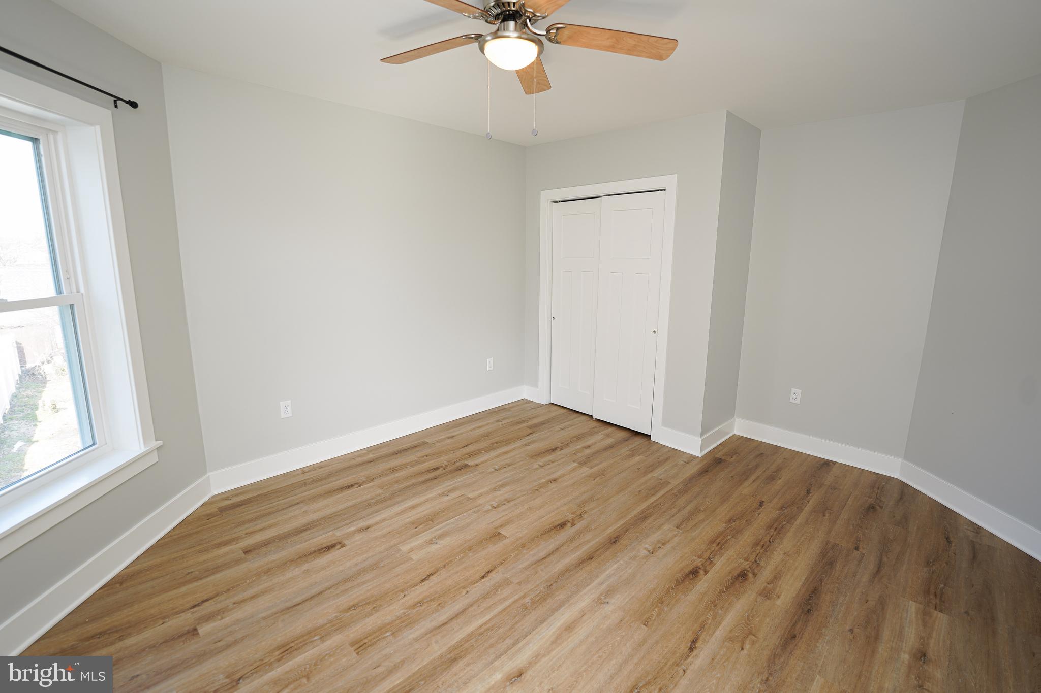 111 East Jewell Street Delmar, DE 19940 - Photo 34 of 59 a view of an empty room with wooden floor and a window