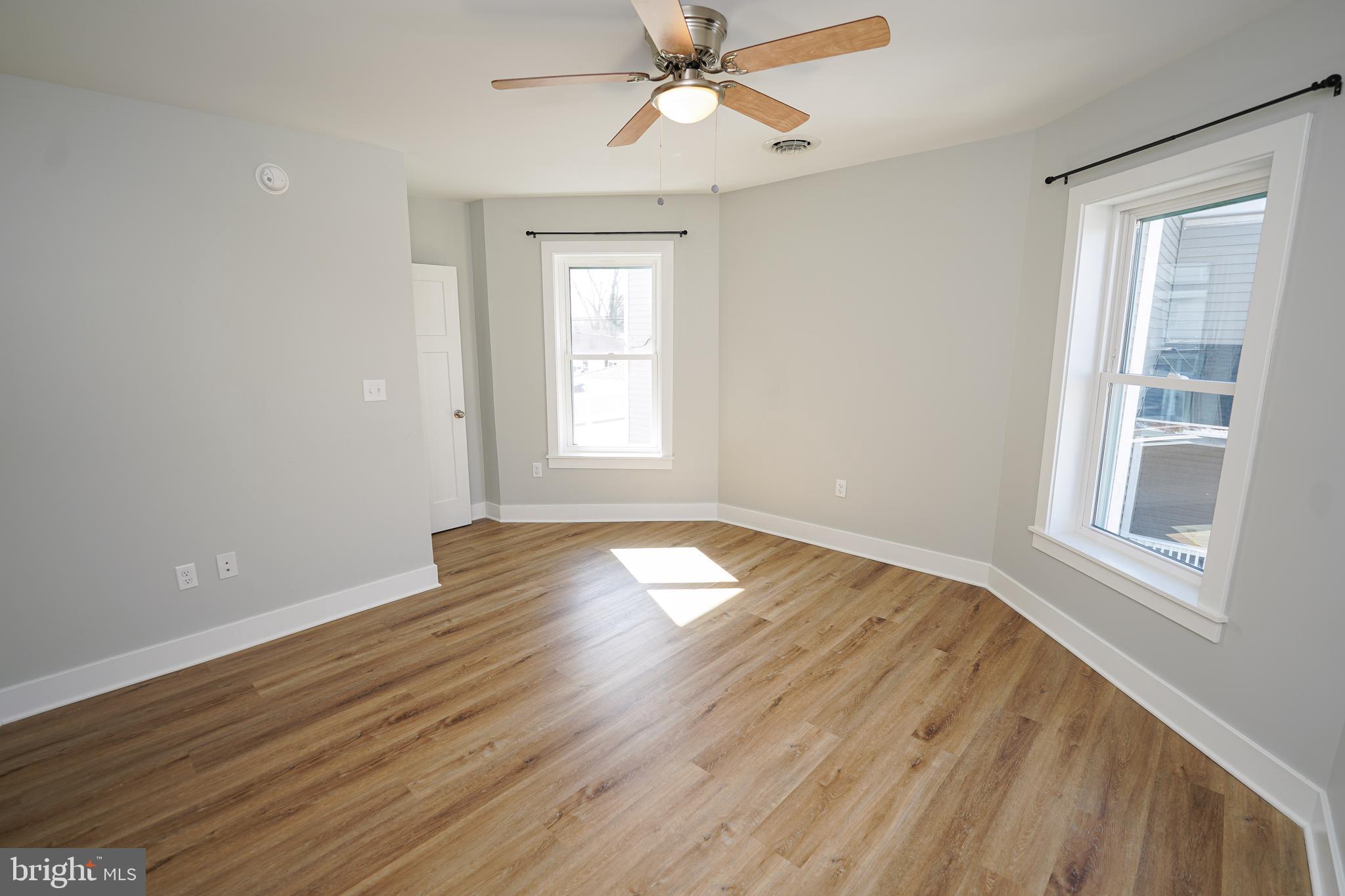 111 East Jewell Street Delmar, DE 19940 - Photo 36 of 59 a view of empty room with wooden floor and fan