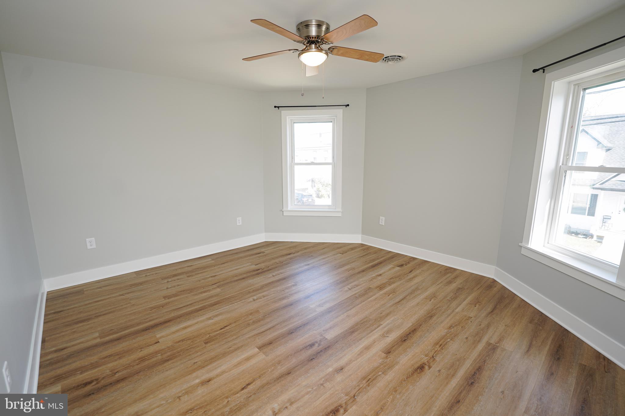 111 East Jewell Street Delmar, DE 19940 - Photo 43 of 59 a view of empty room with wooden floor and fan