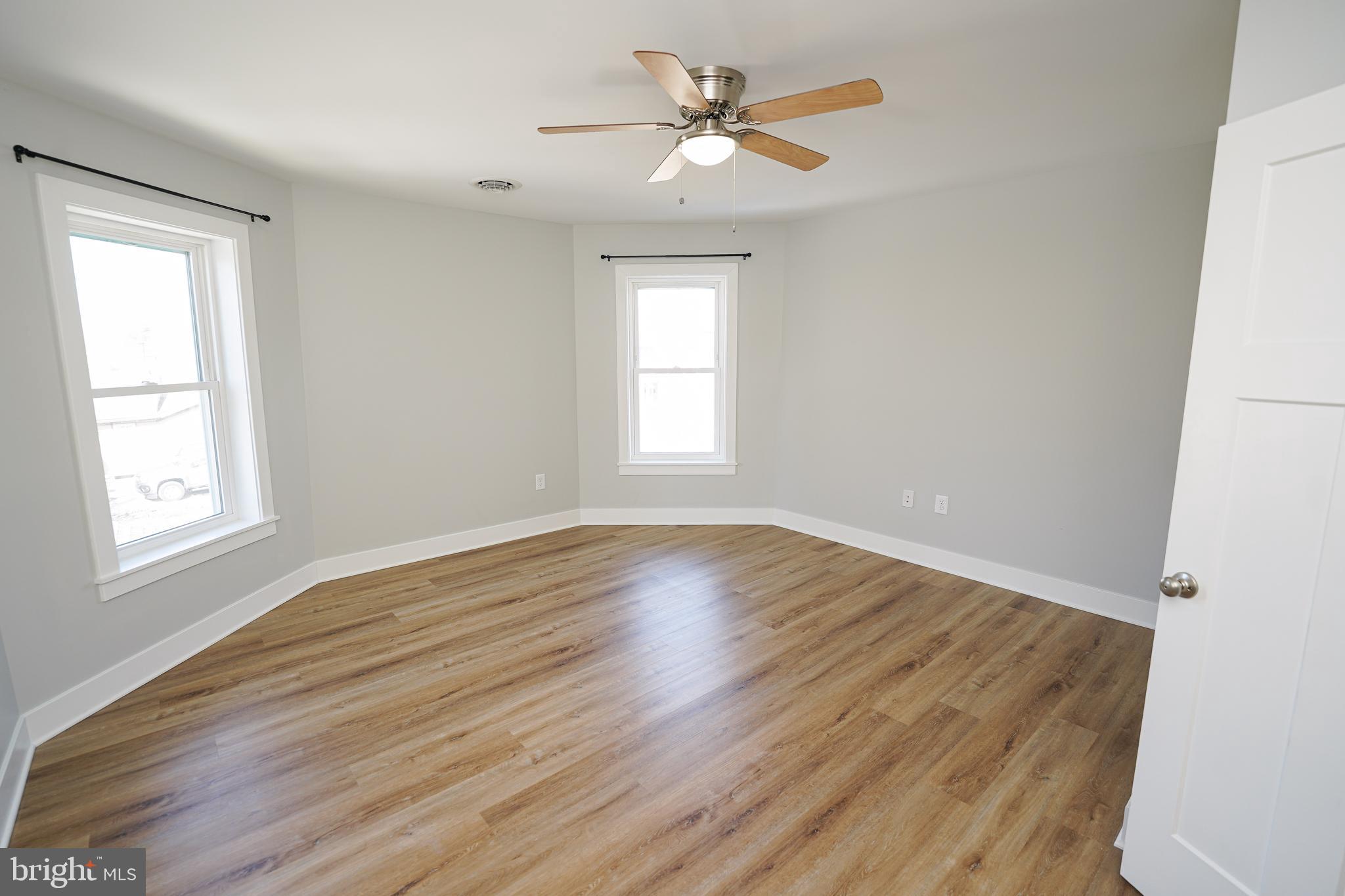 111 East Jewell Street Delmar, DE 19940 - Photo 50 of 59 a view of empty room with wooden floor and fan