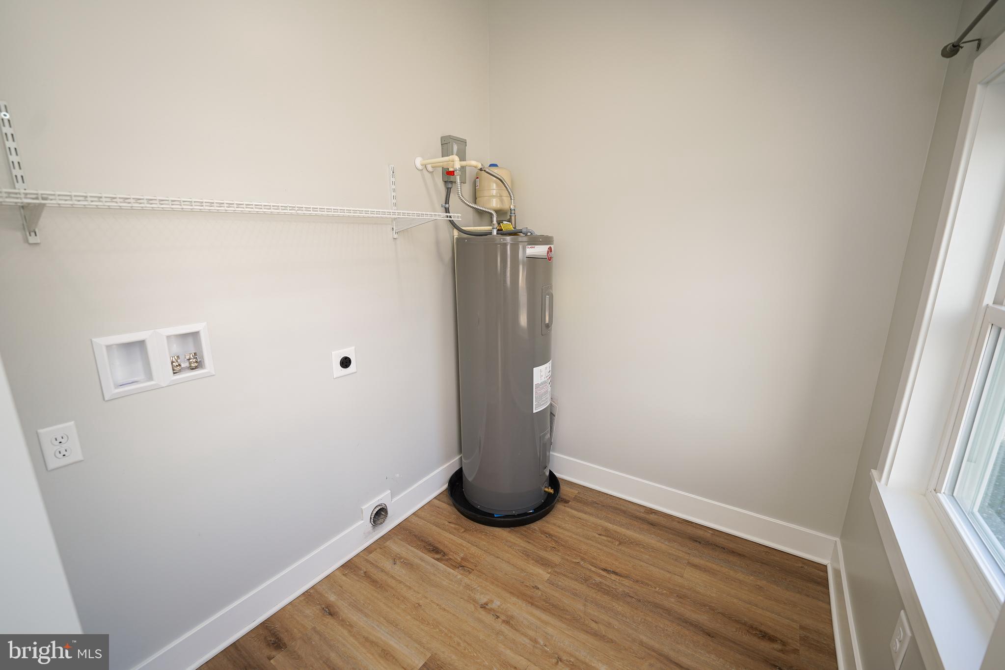 111 East Jewell Street Delmar, DE 19940 - Photo 55 of 59 a view of a room with wooden floor and white walls