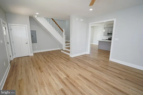 a view of empty room with wooden floor