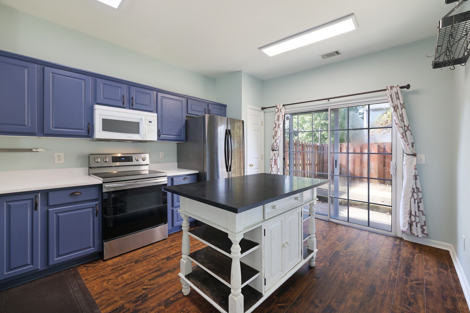 3405 Old Anderson Road, Unit 231 Antioch, TN 37013 - Photo 4 of 18 a kitchen with stainless steel appliances granite countertop a stove a refrigerator and a microwave
