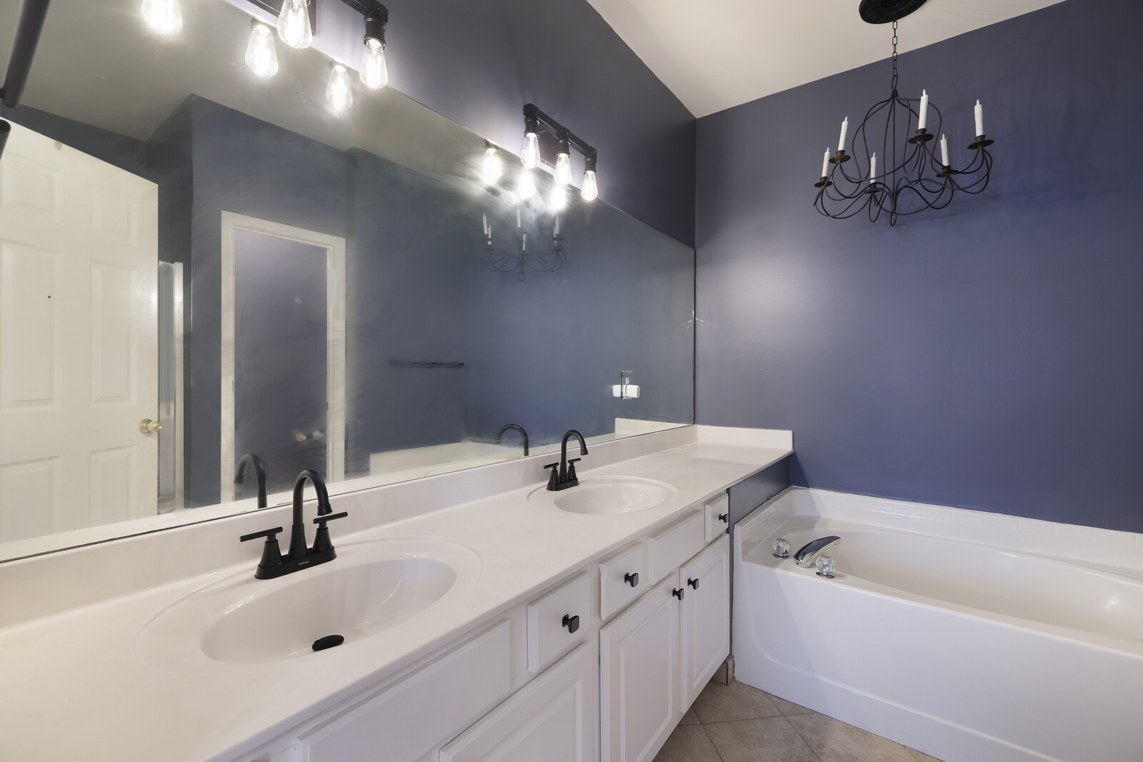 3405 Old Anderson Road, Unit 231 Antioch, TN 37013 - Photo 10 of 18 a bathroom with a sink a large mirror and a bathtub