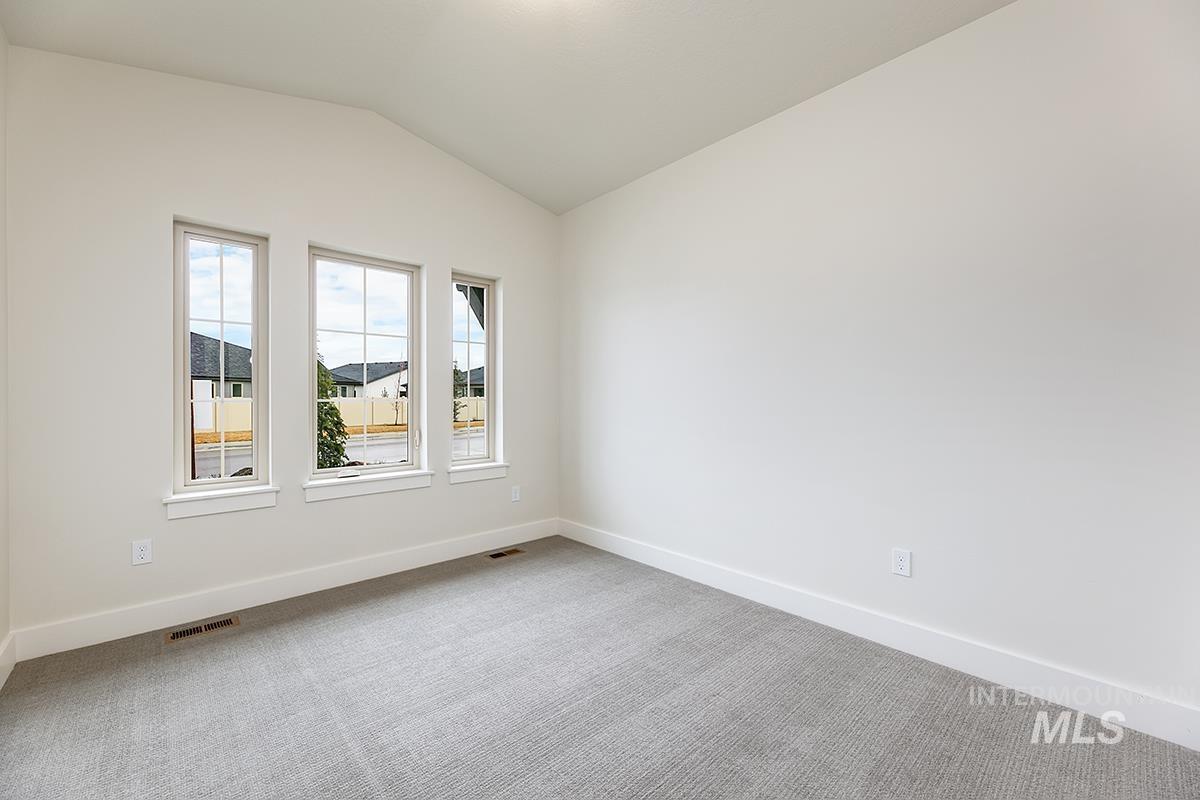 3281 East Englehart Lane Meridian, ID 83642 - Photo 15 of 35 Carpeted empty room with baseboards and vaulted ceiling