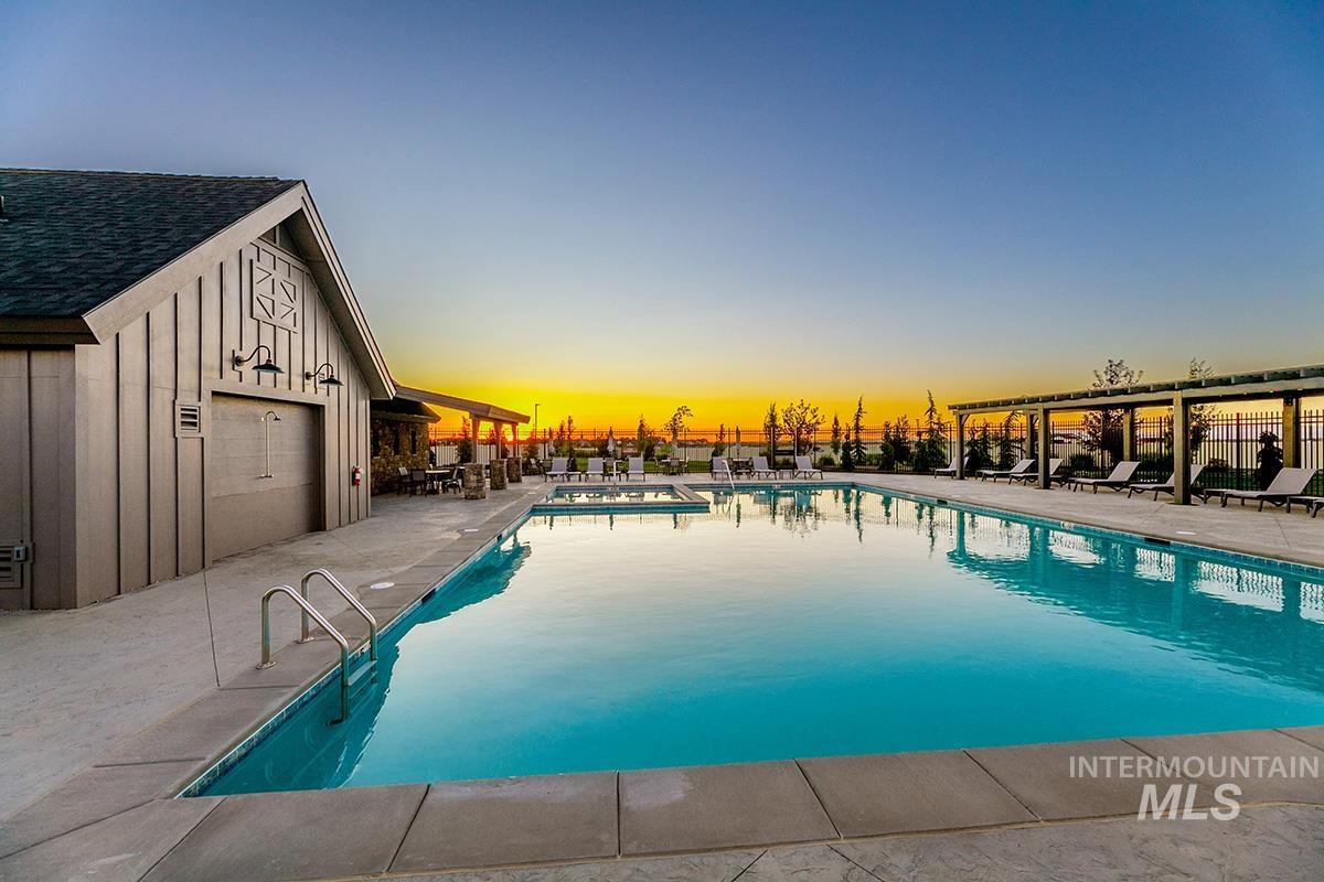 3281 East Englehart Lane Meridian, ID 83642 - Photo 23 of 35 Pool at dusk featuring a patio area and a community pool