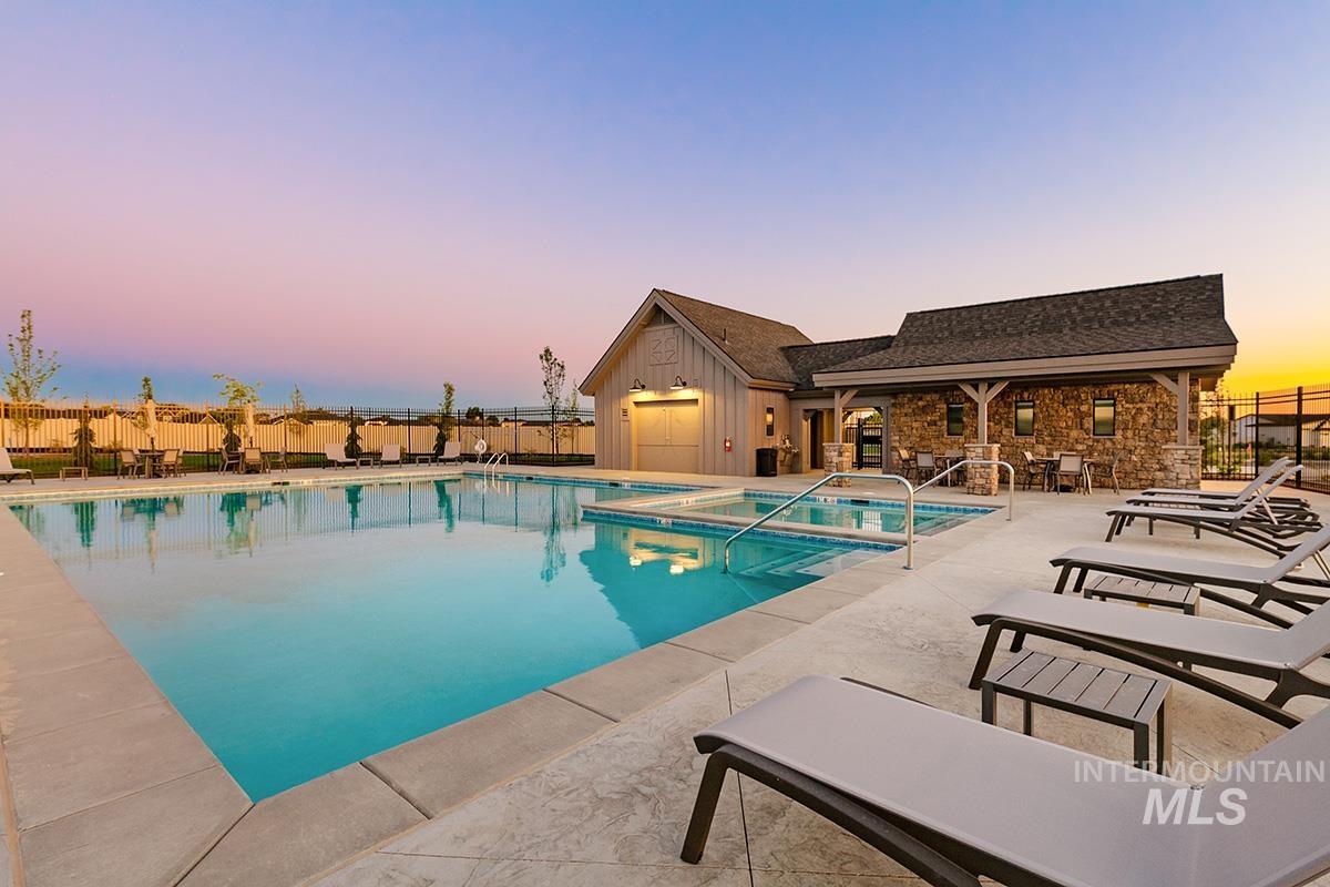 3281 East Englehart Lane Meridian, ID 83642 - Photo 24 of 35 Pool at dusk featuring a patio area and a community pool