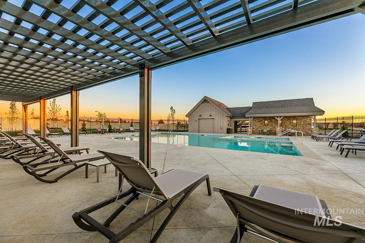 3281 East Englehart Lane Meridian, ID 83642 - Photo 25 of 35 Pool at dusk with a community pool, a patio, and a pergola