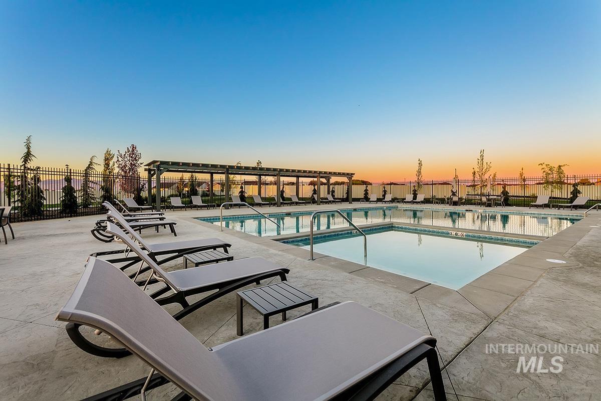 3281 East Englehart Lane Meridian, ID 83642 - Photo 26 of 35 Pool at dusk featuring a community pool and a patio