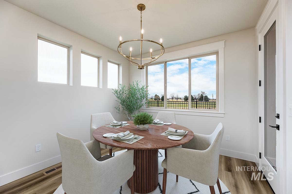 3281 East Englehart Lane Meridian, ID 83642 - Photo 8 of 35 Dining area with plenty of natural light, wood finished floors, and suspended lighting