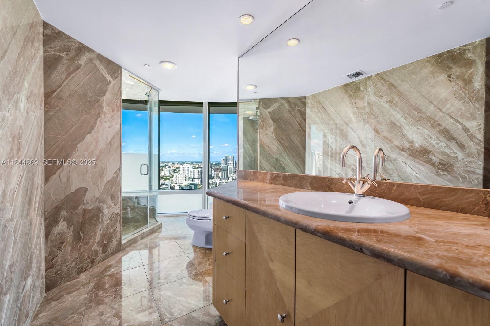 1643 Brickell Avenue, Unit 3702 Miami, FL 33129 - Photo 15 of 32 a bathroom with a granite countertop sink and a mirror