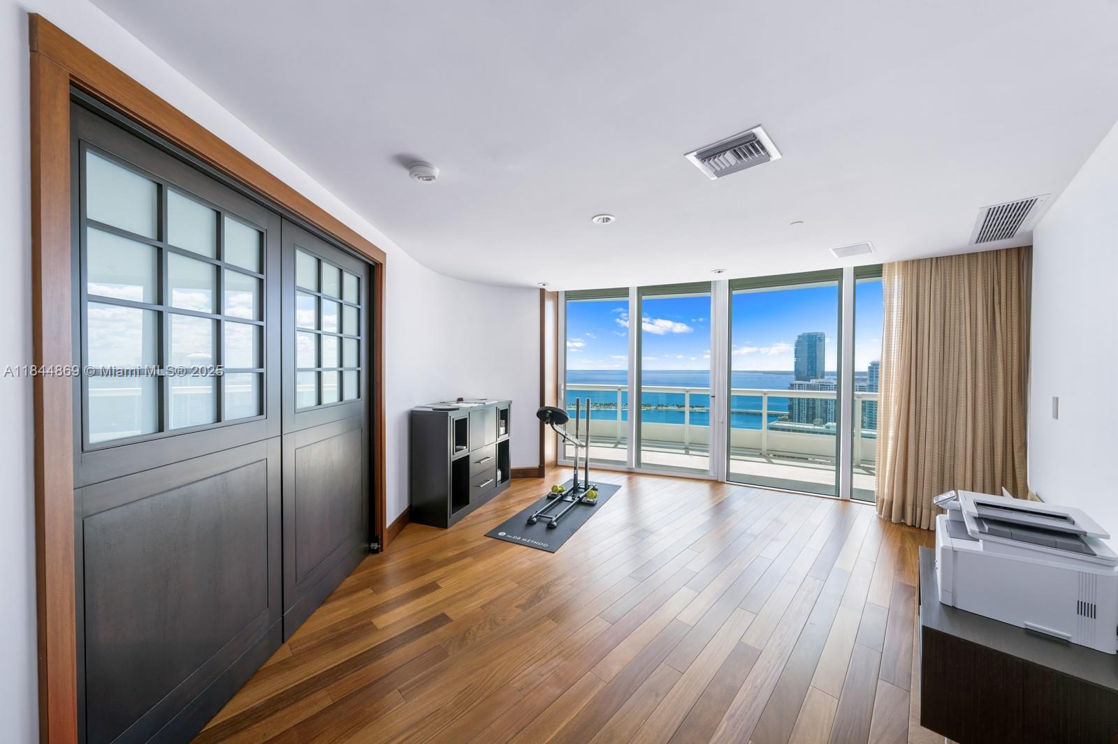 1643 Brickell Avenue, Unit 3702 Miami, FL 33129 - Photo 25 of 32 a room with wooden floor and furniture