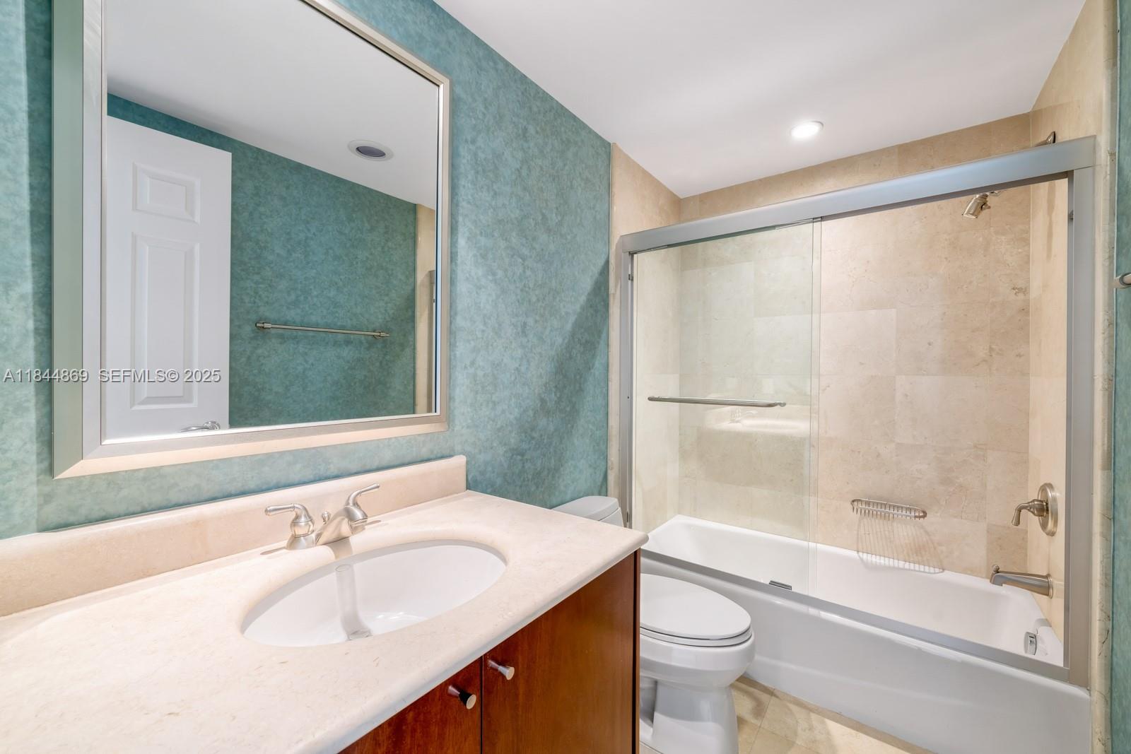 1643 Brickell Avenue, Unit 3702 Miami, FL 33129 - Photo 26 of 32 a bathroom with a sink and a mirror