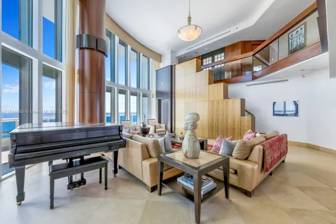 a living room with furniture and a piano
