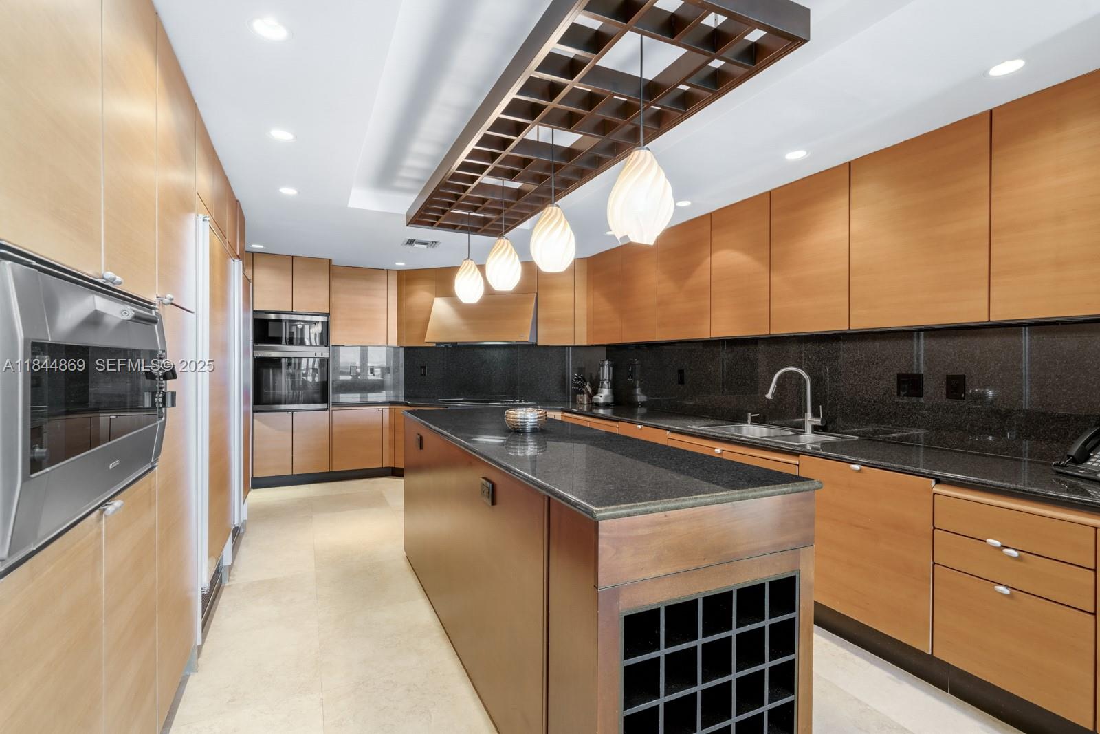 1643 Brickell Avenue, Unit 3702 Miami, FL 33129 - Photo 7 of 32 a kitchen with stainless steel appliances granite countertop a sink a stove and a microwave