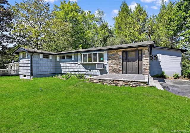 a front view of a house with a garden and yard