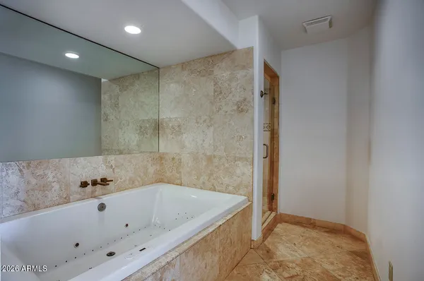 a bathroom with a tub and shower