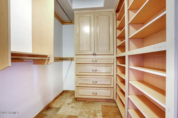 a view of walk in closet with empty racks