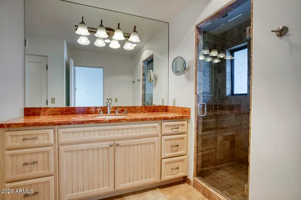 a bathroom with a double vanity sink and a mirror