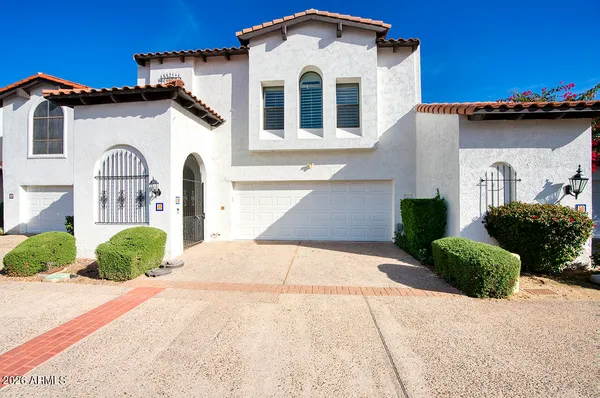 a view of a white house with a outdoor space