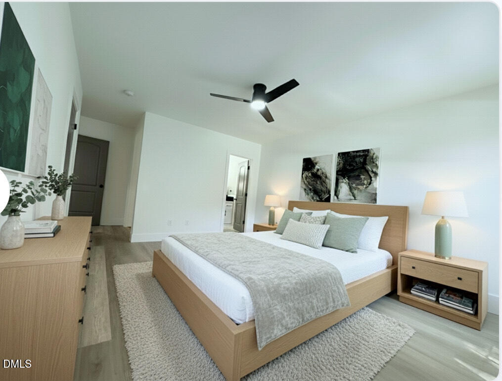 604 South Layton Avenue Dunn, NC 28334 - Photo 11 of 26 a bedroom with a large bed and a chandelier