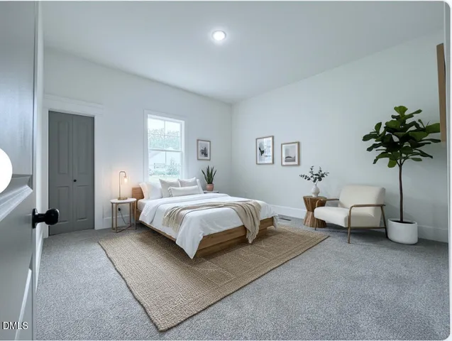 a spacious bedroom with a bed and a potted plant