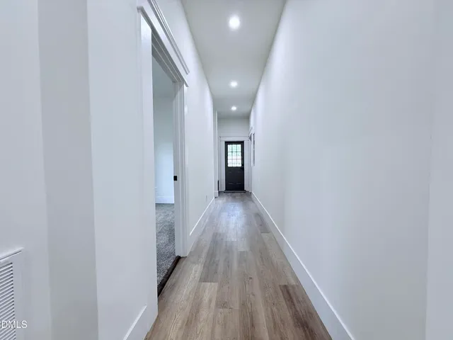 a view of gallery with wooden floor