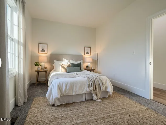 a bedroom with a bed and a night stand