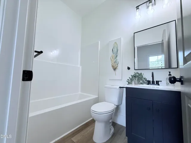 a view of house with backyard and deck