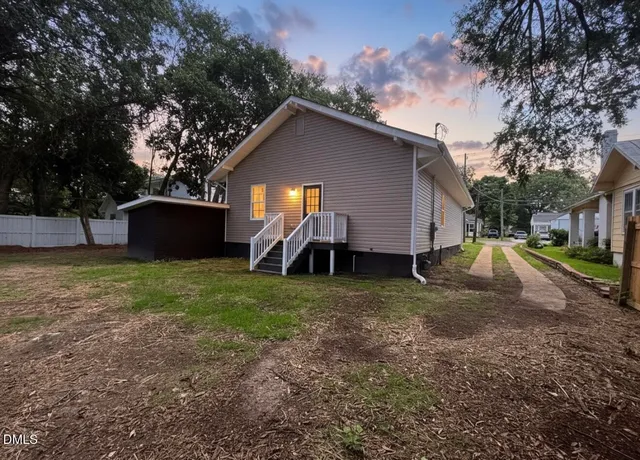 a view of house with backyard