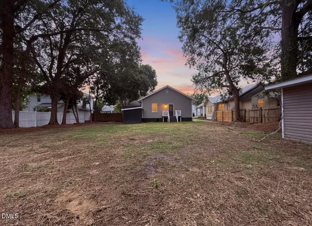 a front view of house with a garden