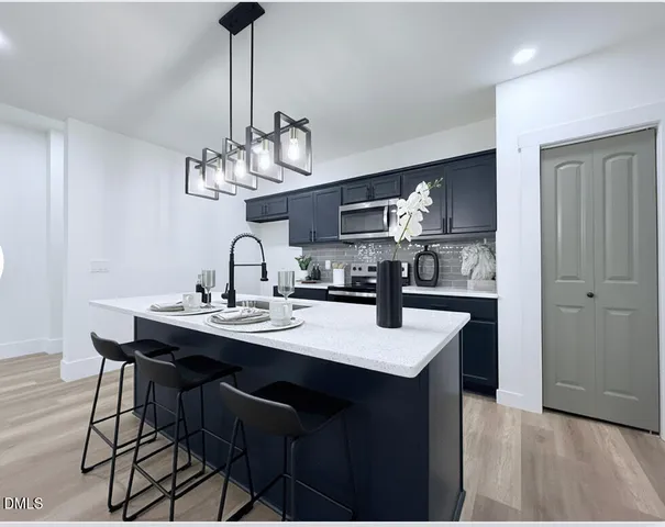 a view of a dining room with furniture a chandelier and wooden floor