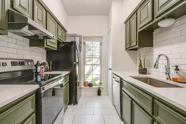 a kitchen with a stove and a refrigerator