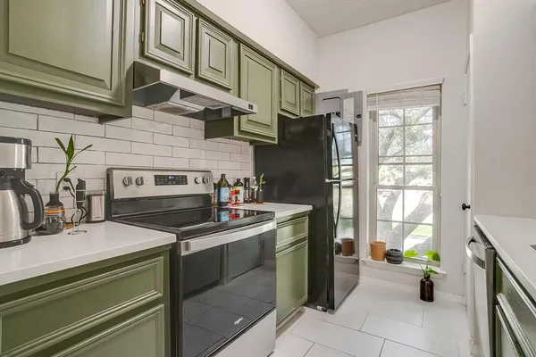 a kitchen with a sink cabinets and a refrigerator