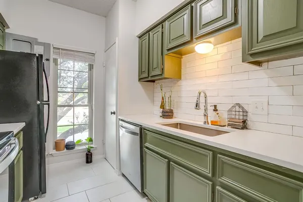 a kitchen with a sink and a stove top oven