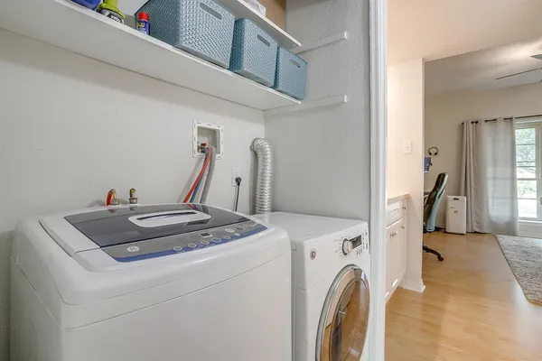 a view of a hallway with washer and dryer
