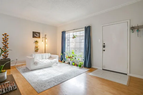 a bedroom with furniture and a flat screen tv