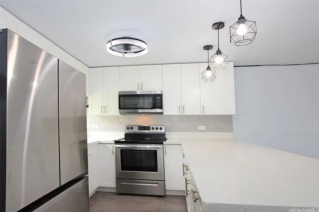 a kitchen with stainless steel appliances a refrigerator sink and microwave