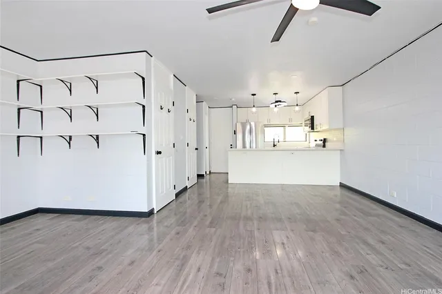 a view of a kitchen with wooden floor and electronic appliances