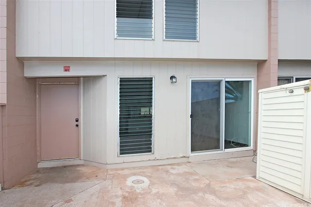 a view of an empty room with closet and a window