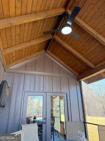 a kitchen with stainless steel appliances granite countertop a refrigerator a oven a sink and a dining table with wooden floor