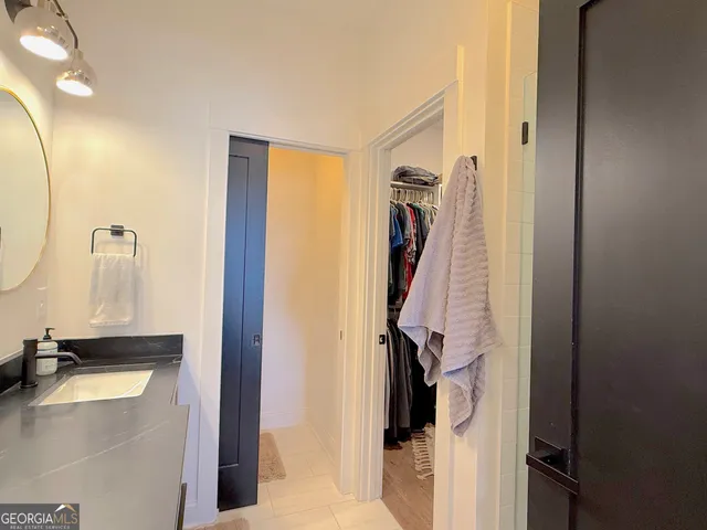 a bathroom with a granite countertop sink a toilet and a mirror