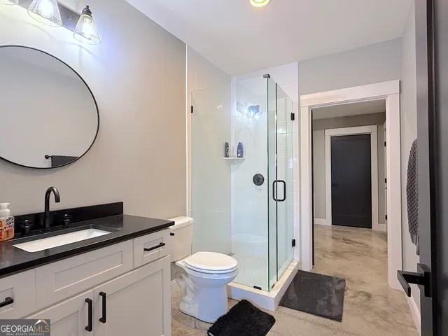 a view of a backyard with a barn and a cactus tree