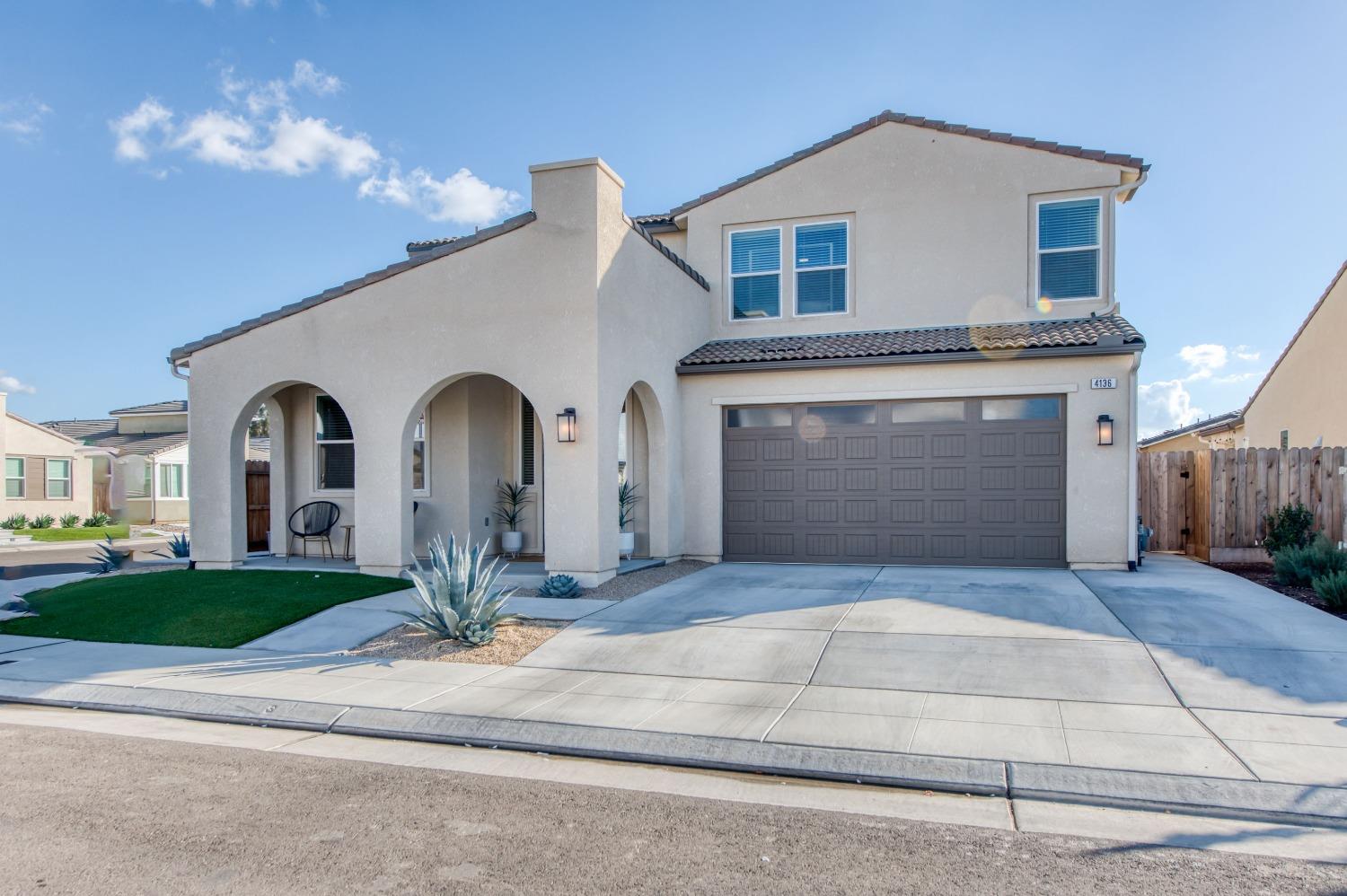 4136 Mecca Avenue Clovis, CA 93619 - Photo 1 of 44 a front view of a house with garden