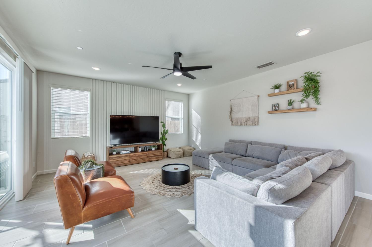 4136 Mecca Avenue Clovis, CA 93619 - Photo 11 of 44 a living room with furniture and a flat screen tv