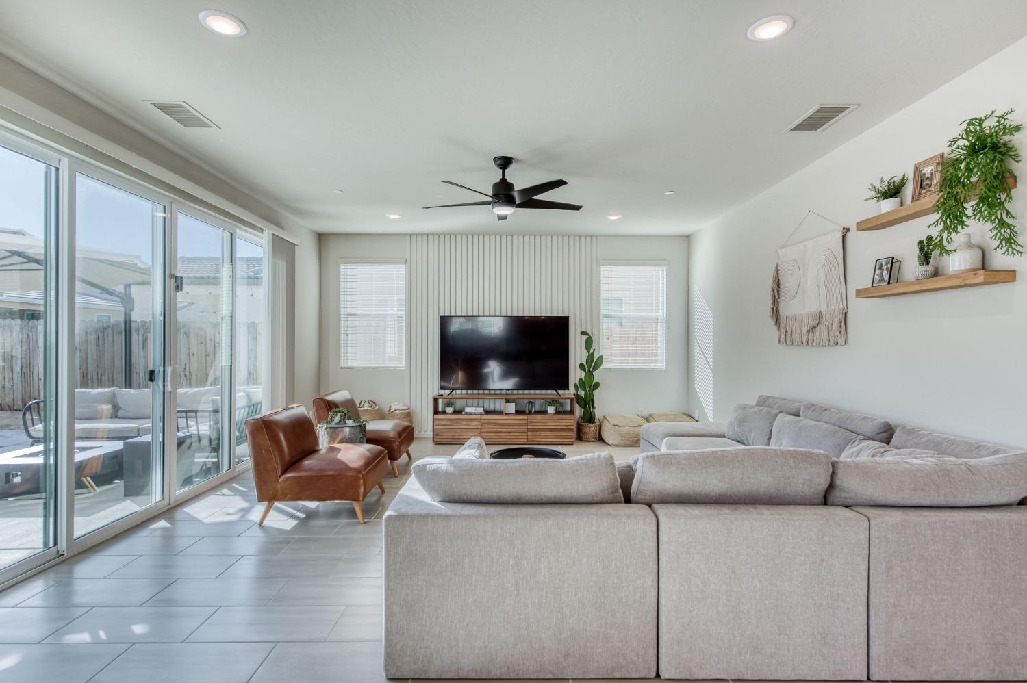 4136 Mecca Avenue Clovis, CA 93619 - Photo 12 of 44 a living room with furniture and a flat screen tv