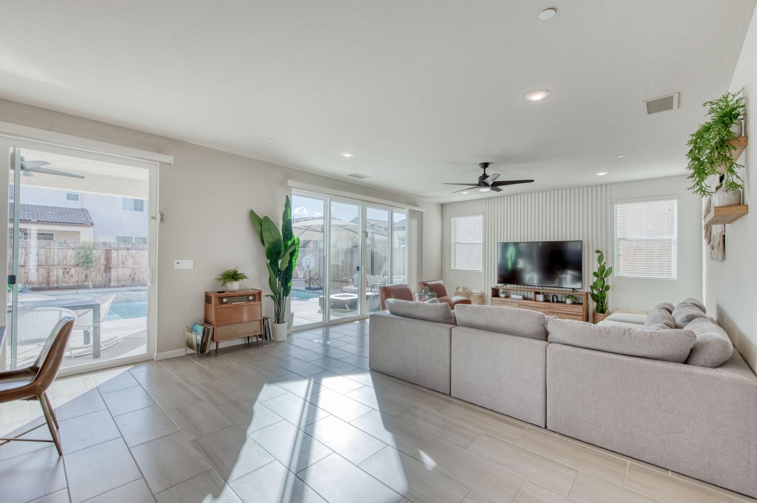 4136 Mecca Avenue Clovis, CA 93619 - Photo 13 of 44 a living room with furniture and a flat screen tv
