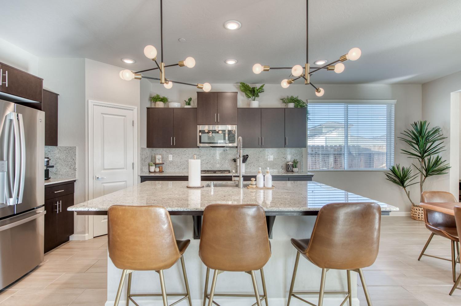 4136 Mecca Avenue Clovis, CA 93619 - Photo 14 of 44 a kitchen with kitchen island granite countertop a counter space cabinets stainless steel appliances and a counter top space