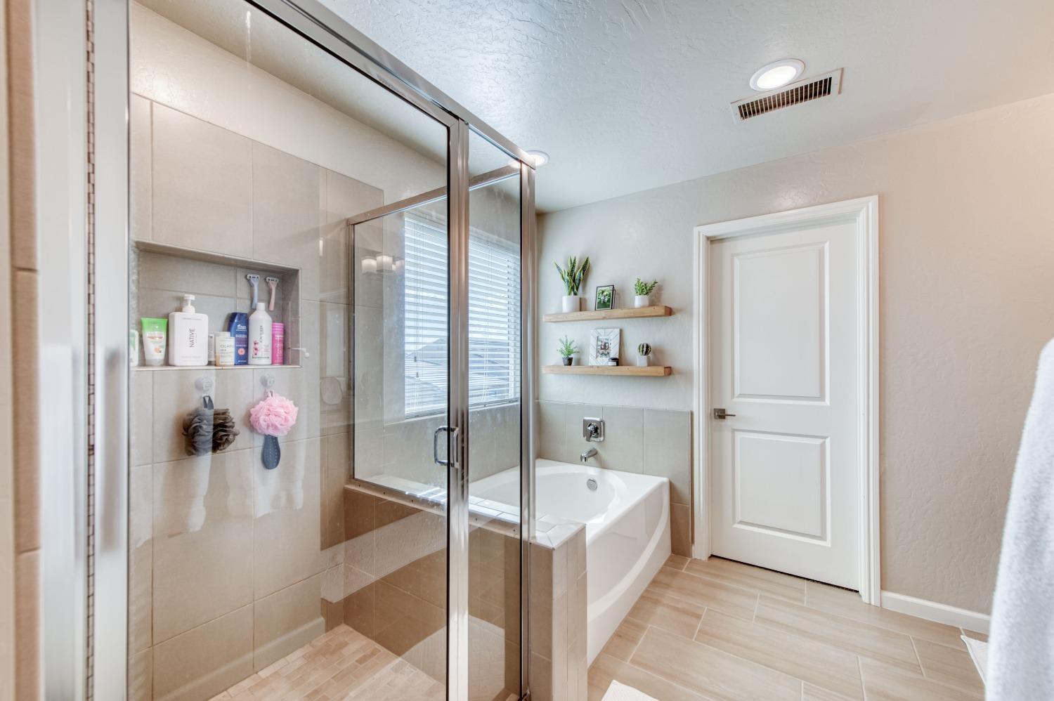 4136 Mecca Avenue Clovis, CA 93619 - Photo 26 of 44 a bathroom with a tub and shower
